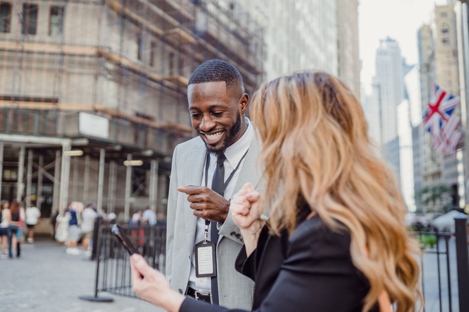 Two business professionals engage in lively conversation on an urban street, sharing insights. — Greenhouses Enhance Crop Pro