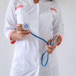 Close-up of a female doctor holding a blue stethoscope, emphasizing healthcare and professionalism. — Revitalize Your Vitalit